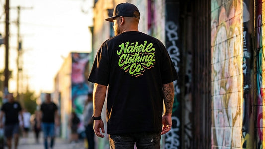 Man walking down a street wearing a black t-shirt with 'Nahene Clothing Co' logo.